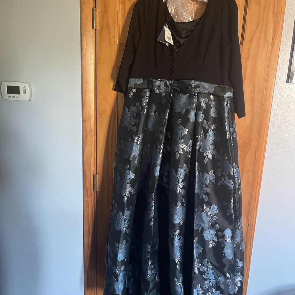 Long gown with black top and jacquard satin skirt.